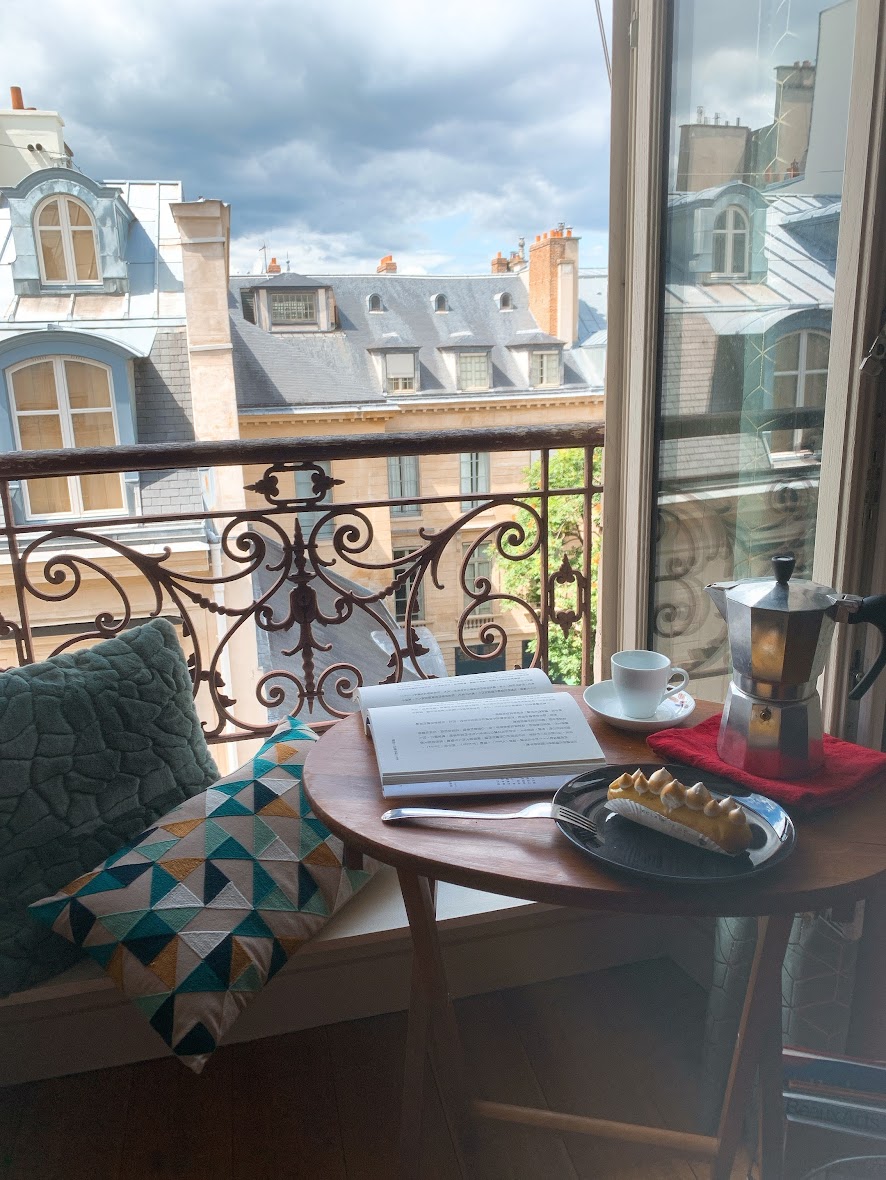 Paris apartment corner with book and dessert